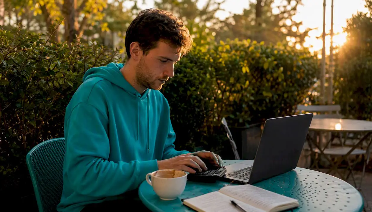 Man typing numeric keypad in coffee shop