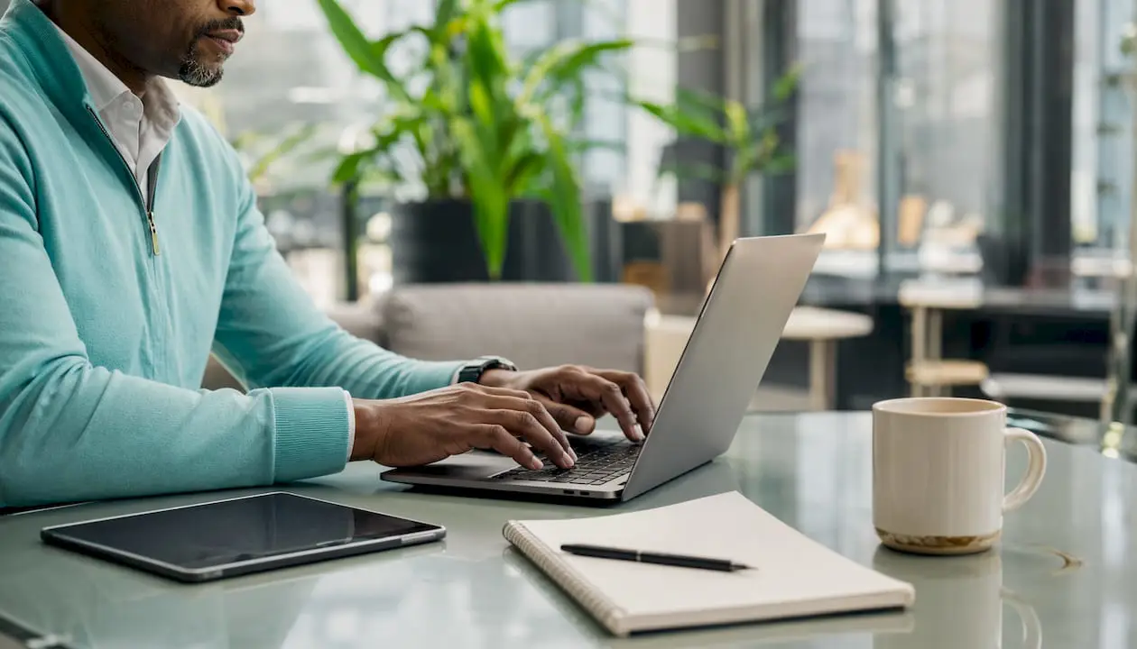 Close-up on hands typing at home office laptop